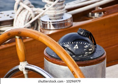 Rudder And Compass On A Wooden Boat