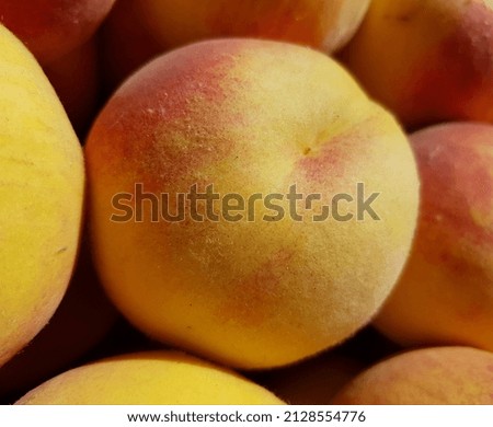 Ruddy fresh peaches (Prunus persica) in the sun (macro, top view, texture).