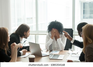 Rude diverse colleagues humiliating offending stressed upset young african woman leader suffering from gender racial discrimination during meeting or feeling exhausted tired of responsibility at work - Shutterstock ID 1085354168