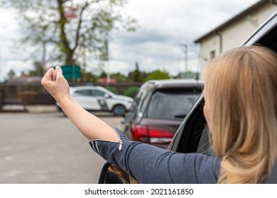 Rude And Furious Driver Showing Fist To Car Behind, Woman Shows Obscene Gesture From A Car