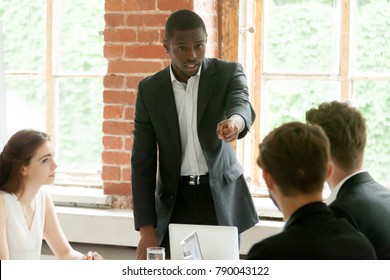 Rude Impolite African Businessman Pointing Finger At Colleague On Team Meeting, Angry Black Boss Scolding White Employee For Bad Work, Multiracial Conflict At Workplace, Obnoxious Behavior In Office