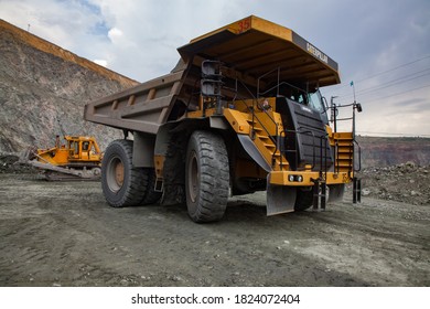 Rudny/Kazakhstan - May 14 2012:  Open-pit mining iron ore in quarry. Caterpillar quarry truck transporting ore to concentrating plant. 