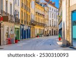 Rue Charrue pedestrian street in Dijon city historical centre with stores, shops and old typical houses medieval buildings, Dijon old town in sunny summer day, Bourgogne-Franche-Comte region, France