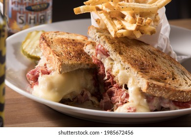 Rueben sandwich on caraway rye bread with fries - Shutterstock ID 1985672456