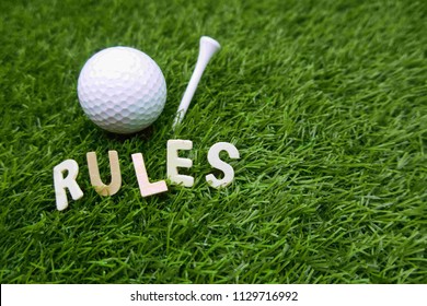 Rues Of Golf With Golf Ball And Rules Word On Green Grass