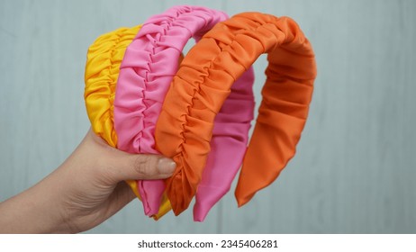 Ruffle headband design made out of beautiful satin fabric in yellow, pink, and orange color. Great hair accessory for girls and women.