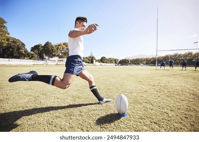 Rugby, action and man kick ball on field for match, tournament or conversion training. Fitness, sports and male athlete with motion for technique, challenge or score between goal post in game - Powered by Shutterstock