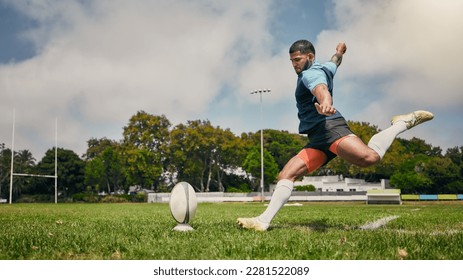 Rugby, action and man kicking ball to score goal on field at game, match or practice workout. Sports, fitness and motion, player running to kick at poles on grass with energy and skill in team sport.