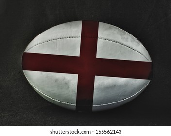 Rugby ball with England flag colors, over black background - Powered by Shutterstock