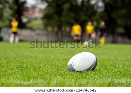 Rugby ball at green grass. Photo taken at rugby training.