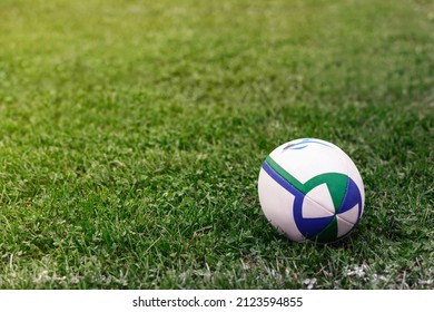 Rugby Ball on Green Field - Rugby Stadium. Rugby Pitch. Copy Space  - Powered by Shutterstock