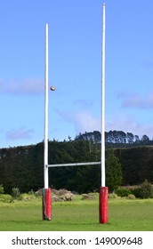 Rugby Ball Passing Through Rugby Goal Posts During Football, Rugby Union Or Rugby League Match Game In Empty Field. No People. Copy Space