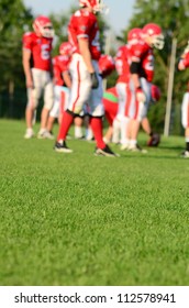 Rugby, Blurred Background With Rugby Or American Football Team On Green Field In A Sunny Day With Copy Space. American Football Team Sport Concept Photo. Sport Background Or Surface