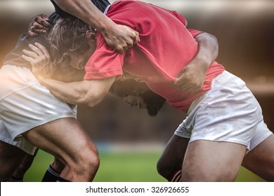 Rugby fans in arena against rugby players doing a scrum - Powered by Shutterstock