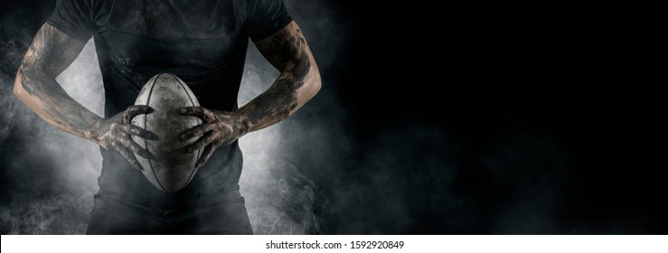 Rugby football player holds ball. Sports banner. Horizontal copy space background - Powered by Shutterstock