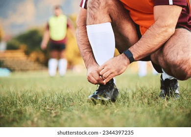 Rugby, hands and athlete tie shoes to start workout, exercise or fitness. Sports, player and man tying boots in training preparation, game or competition for healthy body or wellness on field outdoor - Powered by Shutterstock