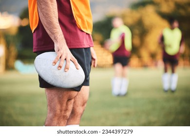 Rugby, man and closeup with ball for sports games, competition and contest on field. Hands of athlete, person and outdoor training at stadium for fitness, exercise and performance challenge on pitch - Powered by Shutterstock