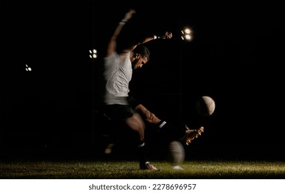 Rugby, night and man kicking ball to score goal at dark stadium at game, match or practice workout. Sports, fitness and motion, player with blurred action on grass with energy and skill in team sport - Powered by Shutterstock