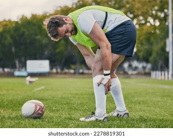 Rugby, pain and man with legs injury on sports field after practice match, training and game outdoors. Medical emergency, accident and male athlete with joint inflammation, knee sprain and tendinitis - Powered by Shutterstock