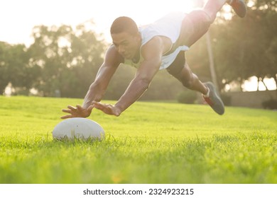 Rugby player in action diving in the air for the ball on the field. - Powered by Shutterstock