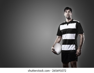 Rugby Player In A Black Uniform On A Black Background.