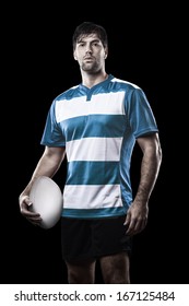 Rugby Player In A Blue Uniform. Black Background.