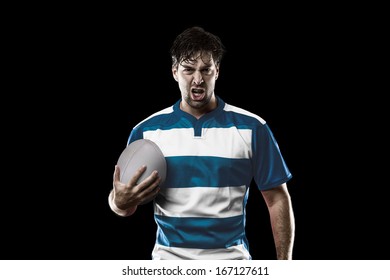 Rugby Player In A Blue Uniform. Black Background.