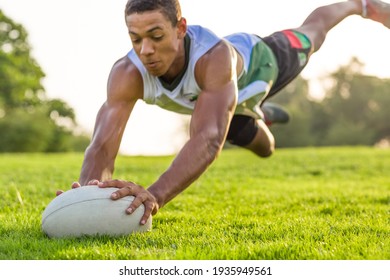 Rugby player diving for the ball in the air action.  - Powered by Shutterstock