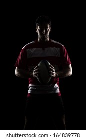 Rugby Player In A Red Uniform. Black Background