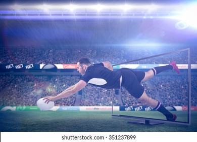 Rugby player scoring a try against rugby stadium - Powered by Shutterstock