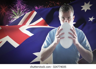 Rugby player throwing a rugby ball against fireworks exploding over football stadium - Powered by Shutterstock