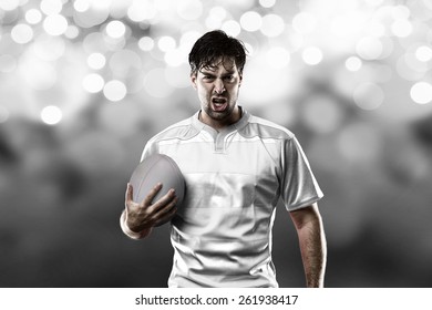 Rugby Player In A White Uniform On A White Lights Background.