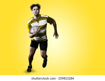 Rugby player in a yellow uniform running on a yellow background. - Powered by Shutterstock