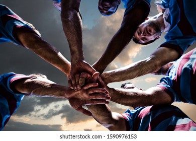 Rugby players against blue and orange sky with clouds - Powered by Shutterstock