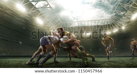 Rugby players fight for the ball on professional rugby stadium