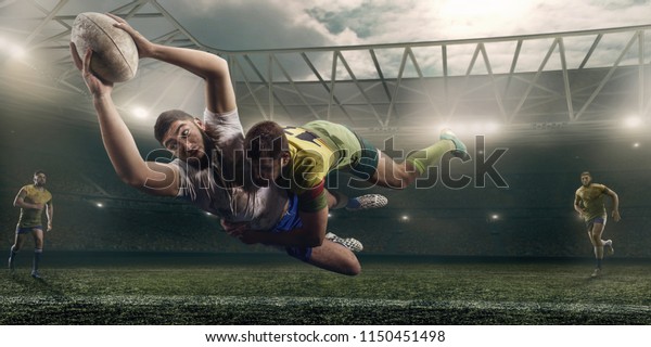 Rugby players fight for the ball on professional\
rugby stadium
