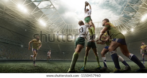 Rugby players fight for the ball on professional\
rugby stadium