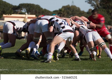 Rugby players grab each other in a dispute for the ball. - Powered by Shutterstock