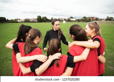 Rugby Players And Their Coach Gathering Before A Match