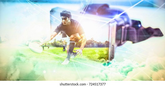 Rugby Players Training On Pitch Against Virtual Reality Headset On Table