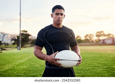 Rugby, portrait and man with ball for sports, game or competition at pitch at sunset. Player, determination and confident athlete at field for body health, exercise and fitness outdoor in Argentina - Powered by Shutterstock