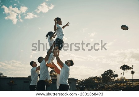 Rugby, team jump and lift for ball and teamwork, sport and training for game, fitness and exercise or sports performance with blue sky. Group, men and lifting man to catch and professional match