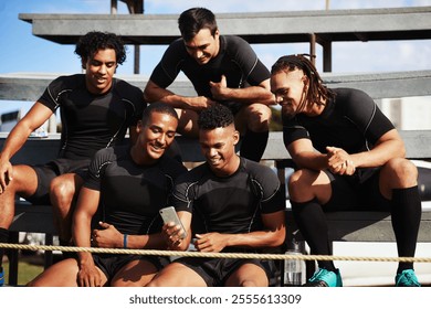 Rugby, team and men with smartphone for sports, social media and streaming video for game on stairs. Group of people, players and break with mobile application for match tips, web and smile on field - Powered by Shutterstock