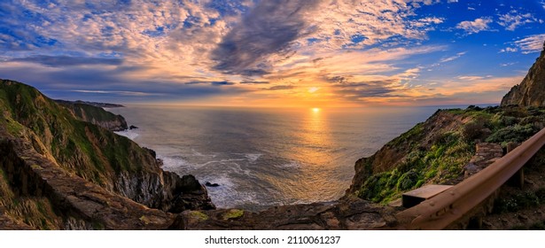 Rugged coastal cliffs by the Devil's Slide trail in California at sunset, and the silky Pacific ocean water from long exposure in the background - Powered by Shutterstock