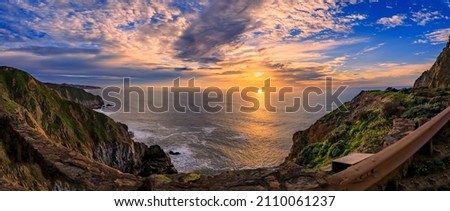 Rugged coastal cliffs by the Devil's Slide trail in California at sunset, and the silky Pacific ocean water from long exposure in the background