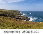 A rugged coastal landscape in western Cornwall, on a sunny summer