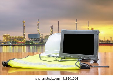 Rugged Computers Tablet In Front Of Oil Refinery Industry