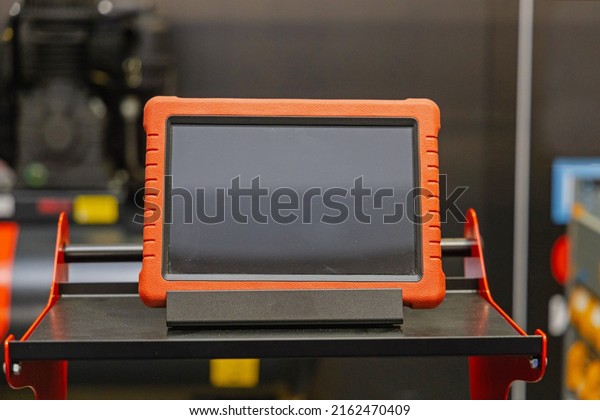 Rugged Electronic Diagnostic Tablet Device in\
Service Garage