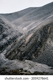 Rugged Mountain Scenery Of Winding Glacial Flows In Grey Colour