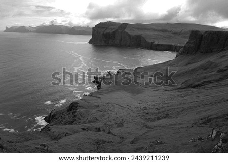 The rugged, raw, and untamed coastline of Vagar's north coast, Faroe Islands, and dramatically captured in this black and white image
